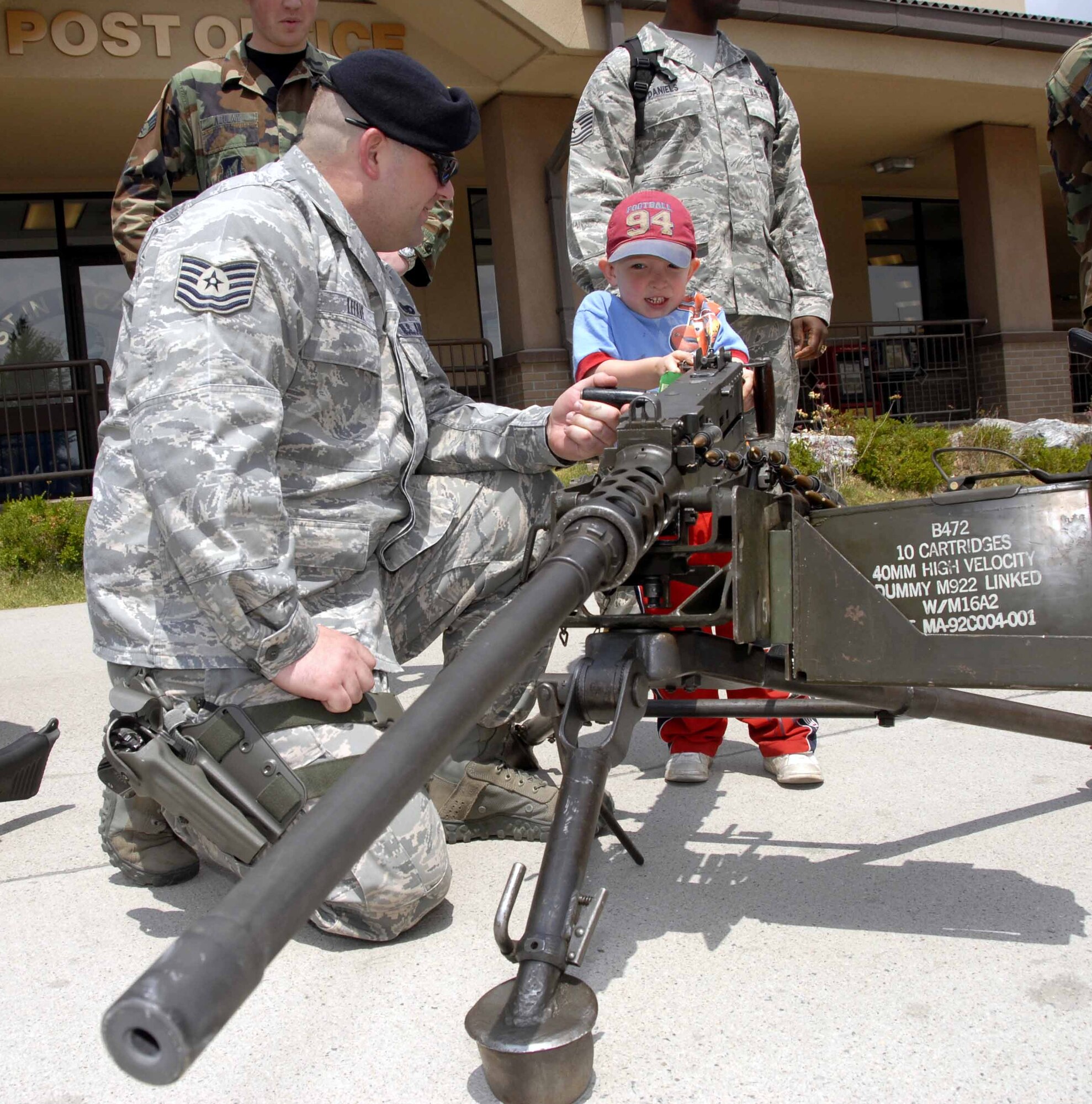 OSAN AIR BASE, Republic of Korea – Tech. Sgt. Jason Lefave, 51st Security Forces Squadron, shows Will Thompson, son of Tech. Sgt. William Thompson, how the M-2 50. caliber machine gun works during a weapons display outside the base exchange May 14. The event was part of Team Osan’s observance of National Police Week, May 11 to 16. (U.S. Air Force photo by Senior Airman Christopher Boitz)