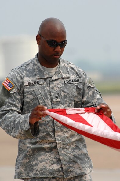 BARKSDALE AIR FORCE BASE, La. -- U.S. Army Staff Sergeants Tramaine Rozier folds the U.S. Flag during the opening ceremony of the Barksdale Air Force Base 2008 Defenders of Liberty Air Show.  The Air Show commemorates the 75th anniversary of Barksdale Air Force Base.  (U.S. Air Force photo by TSgt Laura K. Smith)