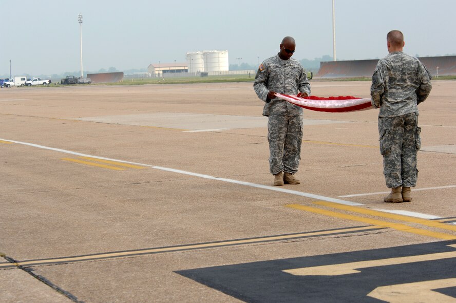 BARKSDALE AIR FORCE BASE, La. -- U.S. Army Staff Sergeants Tramaine Rozier (L) and Timothy Dall fold the U.S. Flag during the opening ceremony of the Barksdale Air Force Base 2008 Defenders of Liberty Air Show.  The Air Show commemorates the 75th anniversary of Barksdale Air Force Base.  (U.S. Air Force photo by TSgt Laura K. Smith)