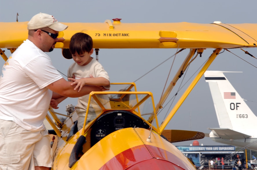BARKSDALE AIR FORCE BASE, La. -- Jesse Shico helps Taylor Lomax, 8, into the cockpit of a 1940's PT-17 Stearman airplane on the flightline of Barksdale Air Force Base, La. during the 2008 Defenders of Liberty Air Show.  The Air Show commemorates the 75th anniversary of Barksdale Air Force Base.  (U.S. Air Force photo by TSgt Laura K. Smith)