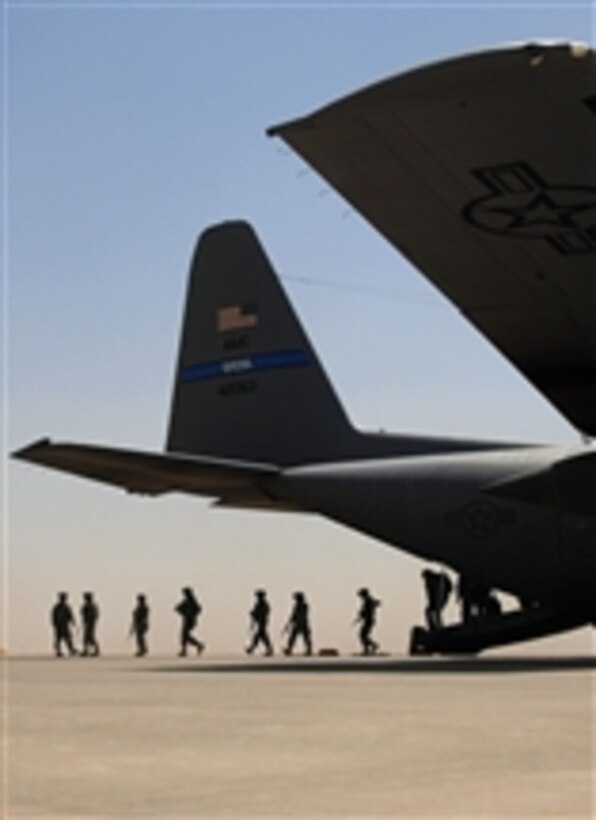 U.S. service members exit a C-130 Hercules aircraft at Balad Air Base, Iraq, on May 10, 2008.  The 777th Expeditionary Airlift Squadron has transported personnel and equipment since it was stood up in January 2006, making it not necessary for approximately 10,000 convoy vehicles and about 27,000 service members to travel along Iraqi roads.  