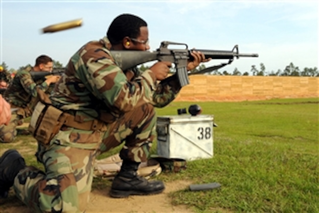 U.S. Navy Petty Officer 2nd Class Adrian Bell fires on his target with a M-16A2E3 service rifle in the kneeling position during his annual Navy rifle qualification, Woolmarket, Miss., May 14, 2008. The rifle qualification is part of each Seabee's homeport training schedule and is updated yearly. Bell is assigned to the Naval Mobile Construction Battalion 7.