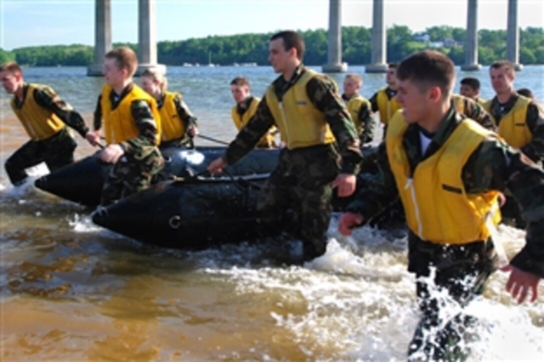 U.S. Naval Academy midshipmen assist their classmates in bringing in the final zodiac combat raiding raft after a race through the harbor during Sea Trials at the academy in Annapolis, Md., May 13, 2008. During the 17-hour event, midshipmen bond together to overcome mental and physical challenges as a team. 