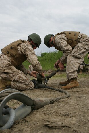 A group of Iraqi Army special forces soldiers practice their combat stance with Marines from Heliborne Assault Platoon, Regimental Combat Team 5, at a range on Al Asad Air Base, Iraq, May 15. The special forces group trains and operates with Marines to assist them in assault missions. Eventually, the Iraqis will be equipped to conduct their own advanced training.