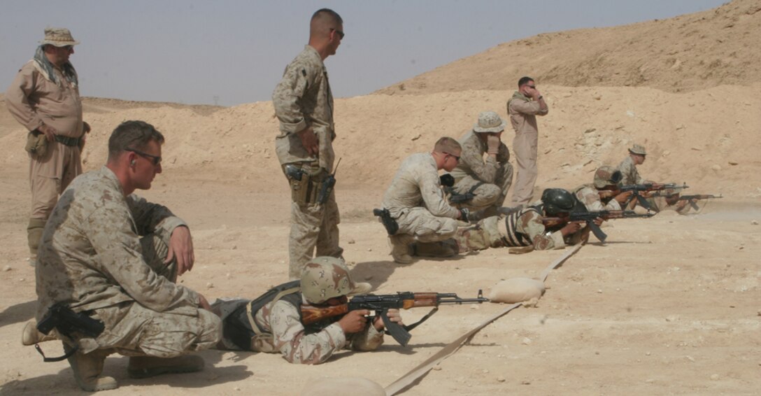 A group of Iraqi Army special forces soldiers fire their AK-47s at targets to sight in their newly issued weapons while Marines with Heliborne Assault Platoon, Regimental Combat Team 5, monitor them and give tips on marksmanship at a range on Al Asad Air Base, Iraq, May15. The IA participated in a combat sustainment course where they first reviewed basic marksmanship and then sighted in their AK-47s.  The special forces group trains and operates with Marines to assist them in assault missions.