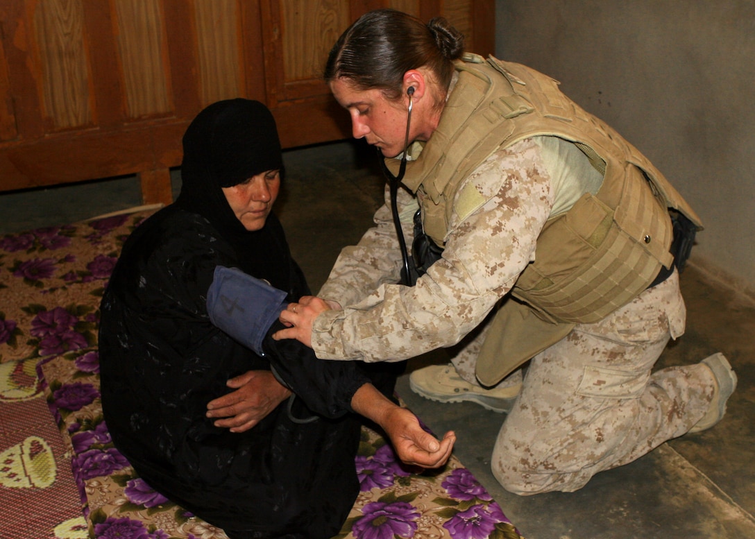 (May 15, 2008) – Navy Petty Officer 2nd Class Traci Inniss, the senior petty officer for Marine Wing Support Squadron 274 checks the blood pressure of an Iraqi woman during a cooperative medical engagement in a local village here today. After discovering the woman’s high blood pressure, the medical personnel were able to prescribe medication to treat the illness.