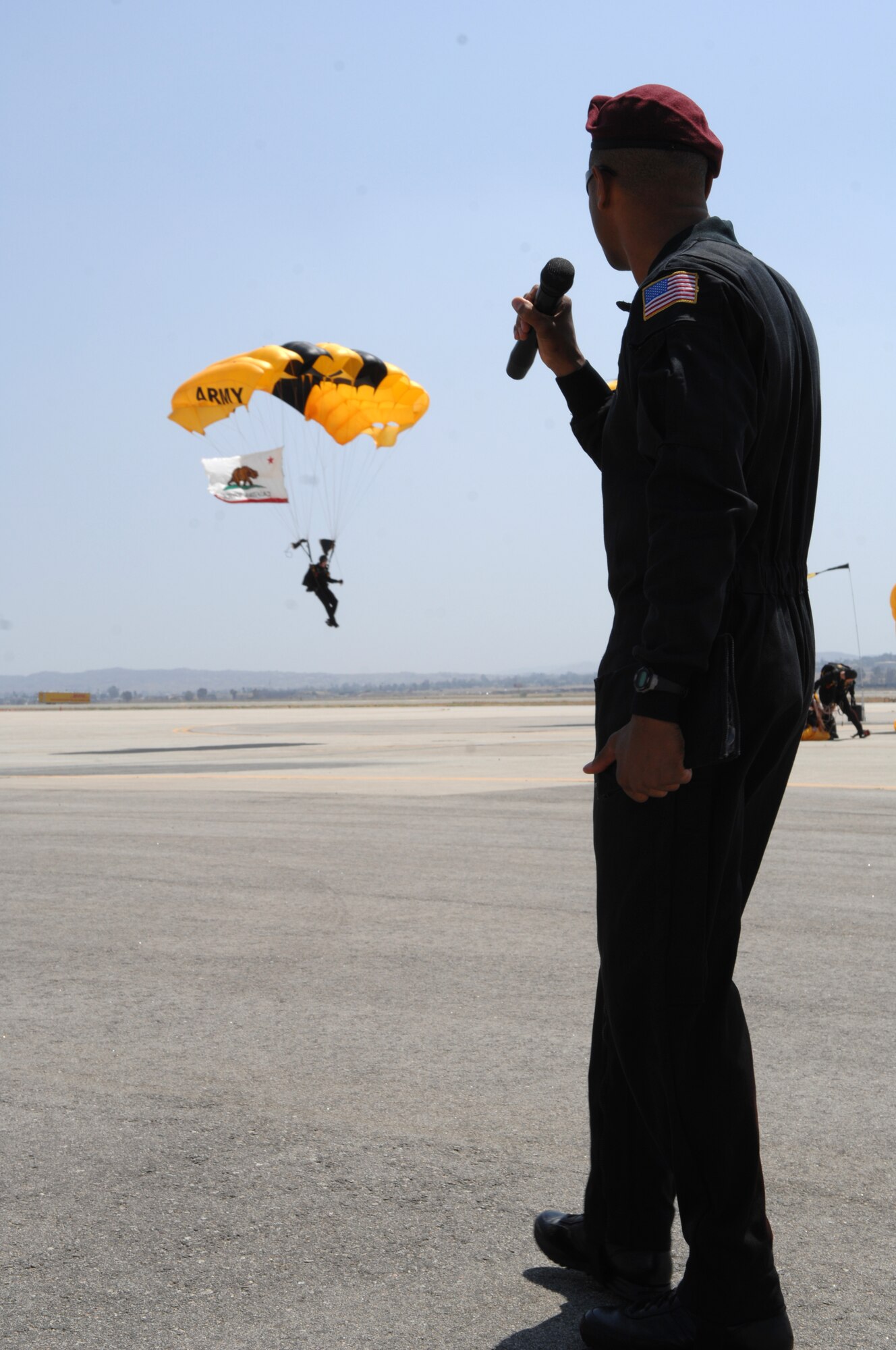 U.S. Army Golden Knights parachute demonstration team land as their actions are narrated before a crowd at the March Air Reserve Base AirFest, Riverside, California on May 2, 2008.  The two day event featured both military and civilian aerial and ground demonstrations and was open to the public. (U.S. Air Force photo by SSgt John Herrick) 