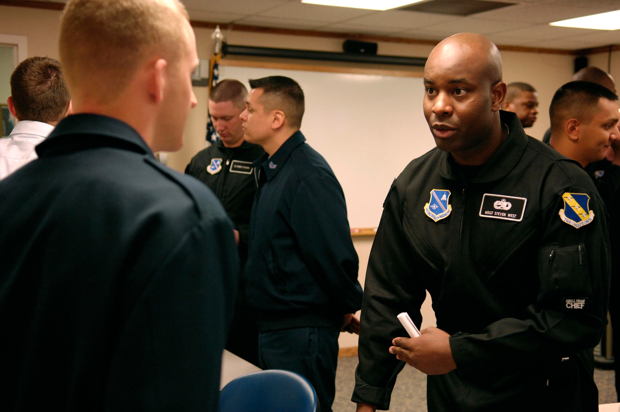 Master Sgt. Steven West, Drill Team Superintendent, speaks with an ALS student at Grand Forks AFB during an AF Honor Guard recruiting briefing.  The AF Honor Guard Drill Team is the traveling component of the AF Honor Guard and tours world-wide representing all Airmen and showcasing USAF precision to recruit, retain, and inspire for the Air Force mission. (U.S. Air Force photo by Senior Airman Dan DeCook)(Released)