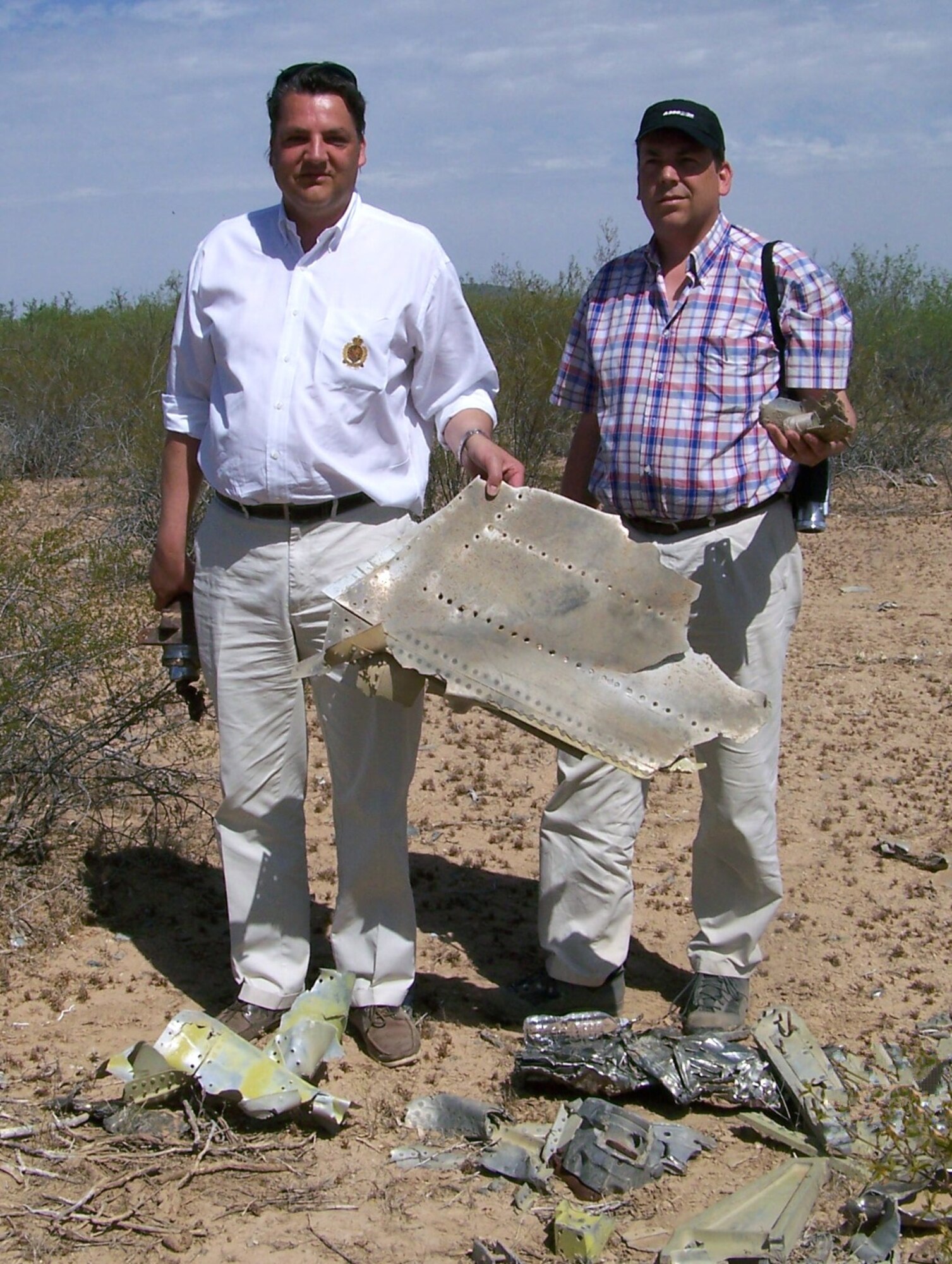 Christoph and Wulf Hoeflich stand amidst remnants of their father's F-104 on the Tohono O'odham Nation. Their father was training at Luke in the Cactus Starfighter Squadron when he was killed in a 1973 mid-air collison in the Sells military operating area.