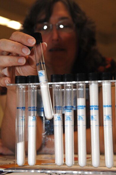 Beverly Moreau-Kelley, employee of WIC (Women Infants and Children), shows the difference in various food products by the sugar intake of each individual food sample at the deployment expo. The Deployment Expo is a briefing to provide information to both single and married military members and families about pre-deployment, deployment, and post deployment support. The Deployment Expo was held at the Community Activity Center, May 13, Holloman Air Force Base, N.M.   

(U.S. Air Force photo/Senior Airman Anthony Nelson Jr)
