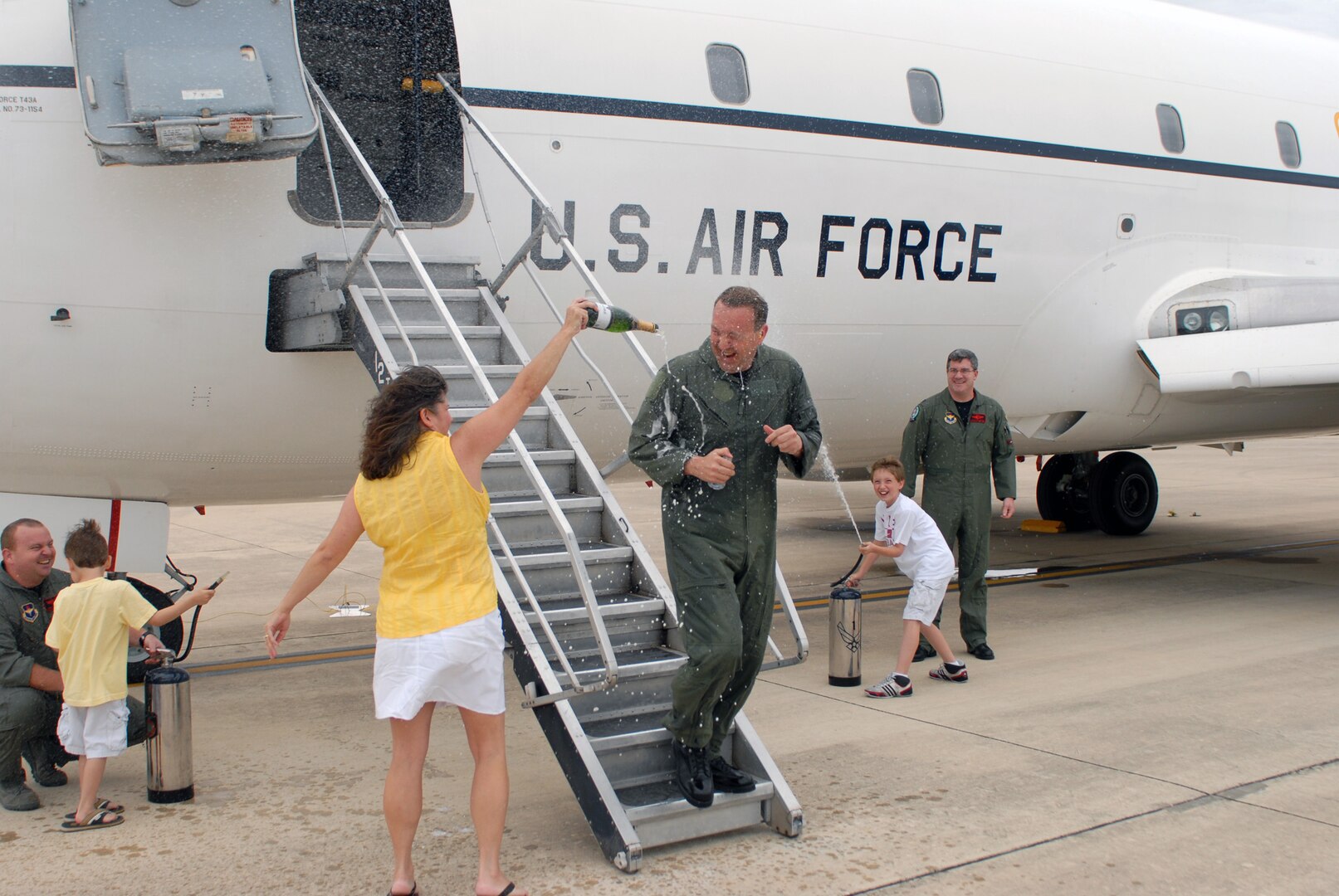 Lt. Col. Kenneth Duck, 563rd Flying Training Squadron commander, is doused by his wife, Brenda, and son, Chandler, as he completes his fini flight here in his T-43 aircraft. Colonel Duck will relinquish command to Lt. Col. Christopher Wellborn, 563rd FTS director of operations, May 16. (U.S. Air Force photo by Rich McFadden)
