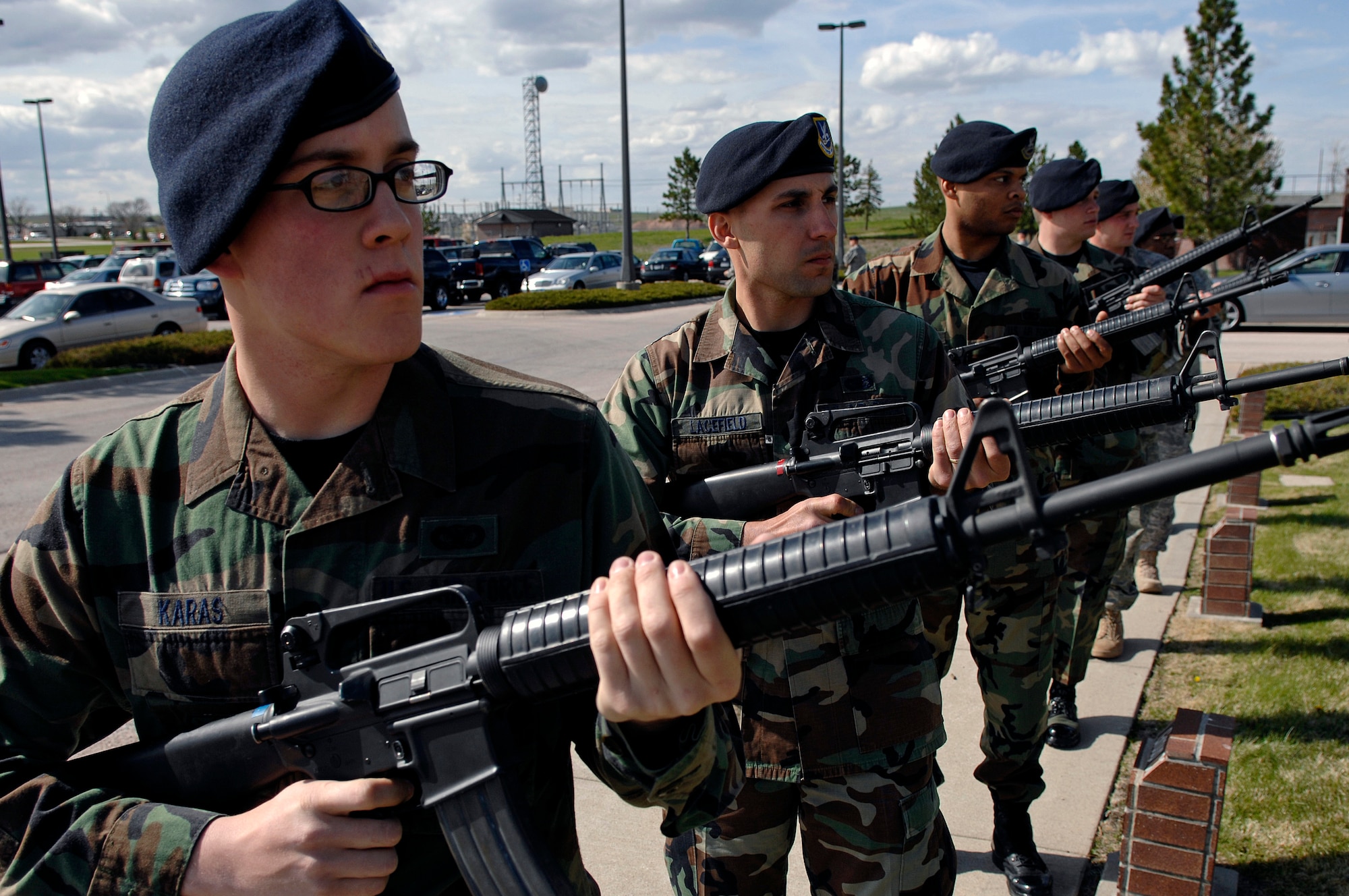 Airman 1st Class Zachary Karas, 28th Security Forces Squadron member, and others from the 28 SFS render a small arms salute during the National Peace Officers Memorial Day retreat ceremony here, May 15. The National Peace Officers Memorial Day honors all the local, state, and federal law enforcement officers who serve and protect. (U.S. Air Force photo/Senior Airman Marc I. Lane)


