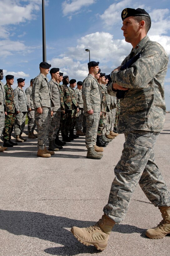 Maj. Erik Bruce, 28th Security Forces Squadron commander, returns to the 28th Bomb Wing headquarters after receiving the flag during the National Peace Officers Memorial Day retreat ceremony here, May 15. The National Peace Officers Memorial Day annually recognizes the dedication to duty and courage displayed by police officers. (U.S. Air Force photo/Senior Airman Marc I. Lane)

