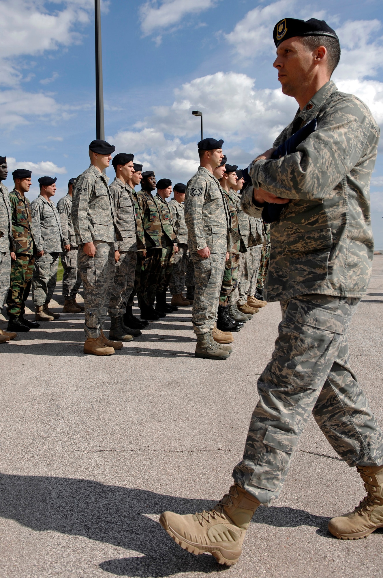Maj. Erik Bruce, 28th Security Forces Squadron commander, returns to the 28th Bomb Wing headquarters after receiving the flag during the National Peace Officers Memorial Day retreat ceremony here, May 15. The National Peace Officers Memorial Day annually recognizes the dedication to duty and courage displayed by police officers. (U.S. Air Force photo/Senior Airman Marc I. Lane)


