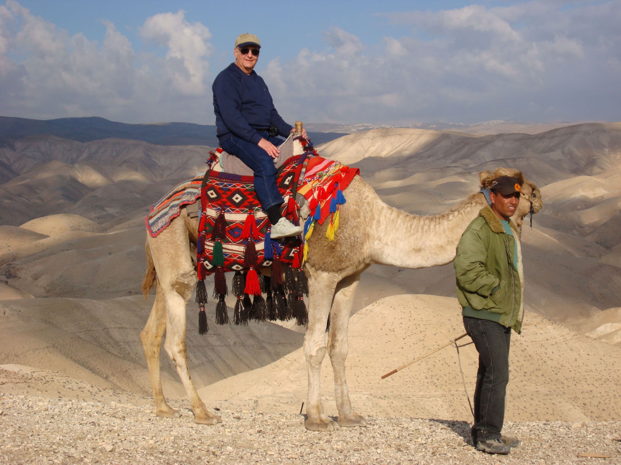 Jim Johnson takes a break from walking and rides a camel in the wilderness area between Jericho and Jerusalem. (Photo provided)