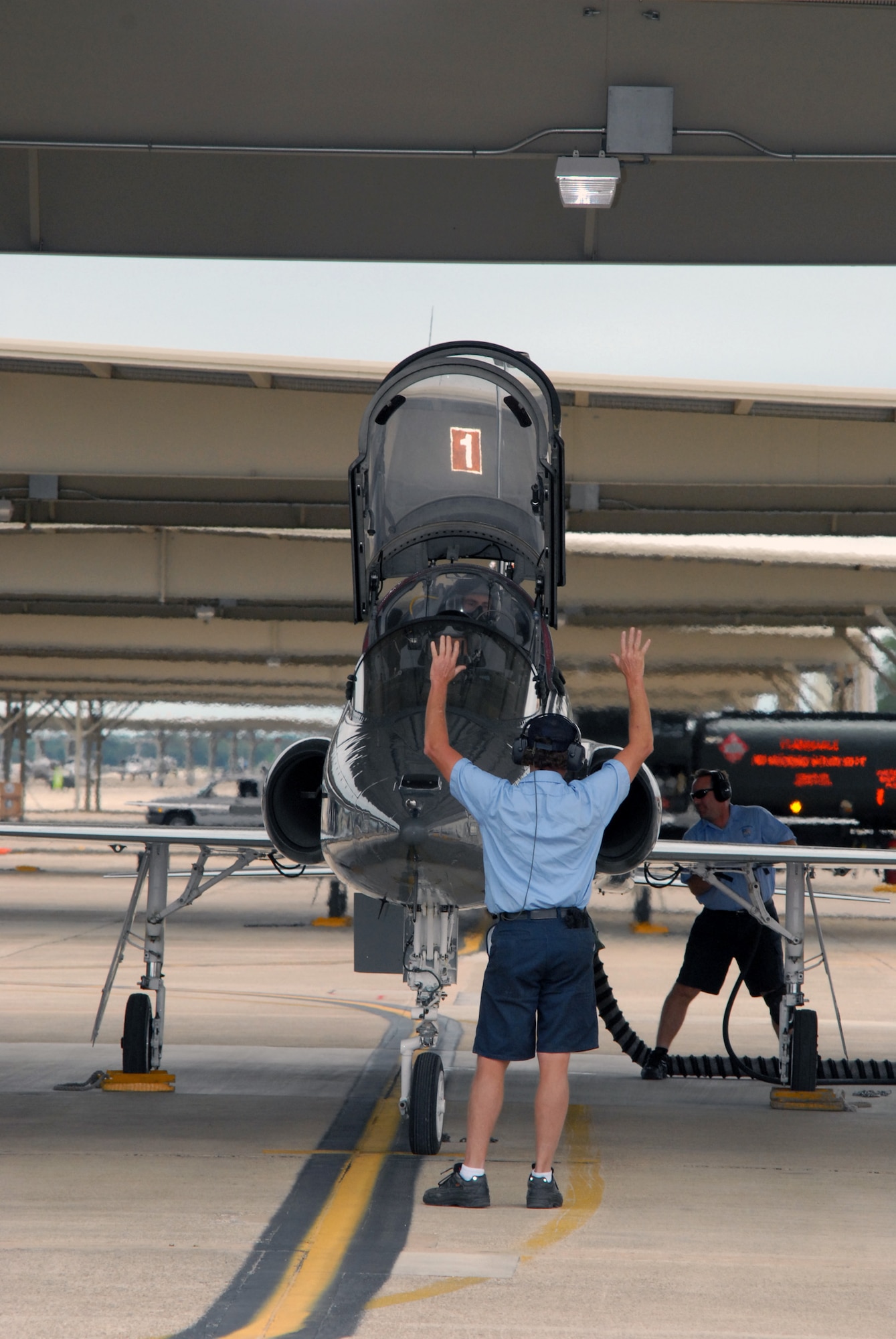 Bill Monk, a T-38 crewman from the 12th Maintenance Division, readies the pilot and aircraft prior to taxi and takeoff for a routine training mission here. (U.S. Air Force photo by Rich McFadden)