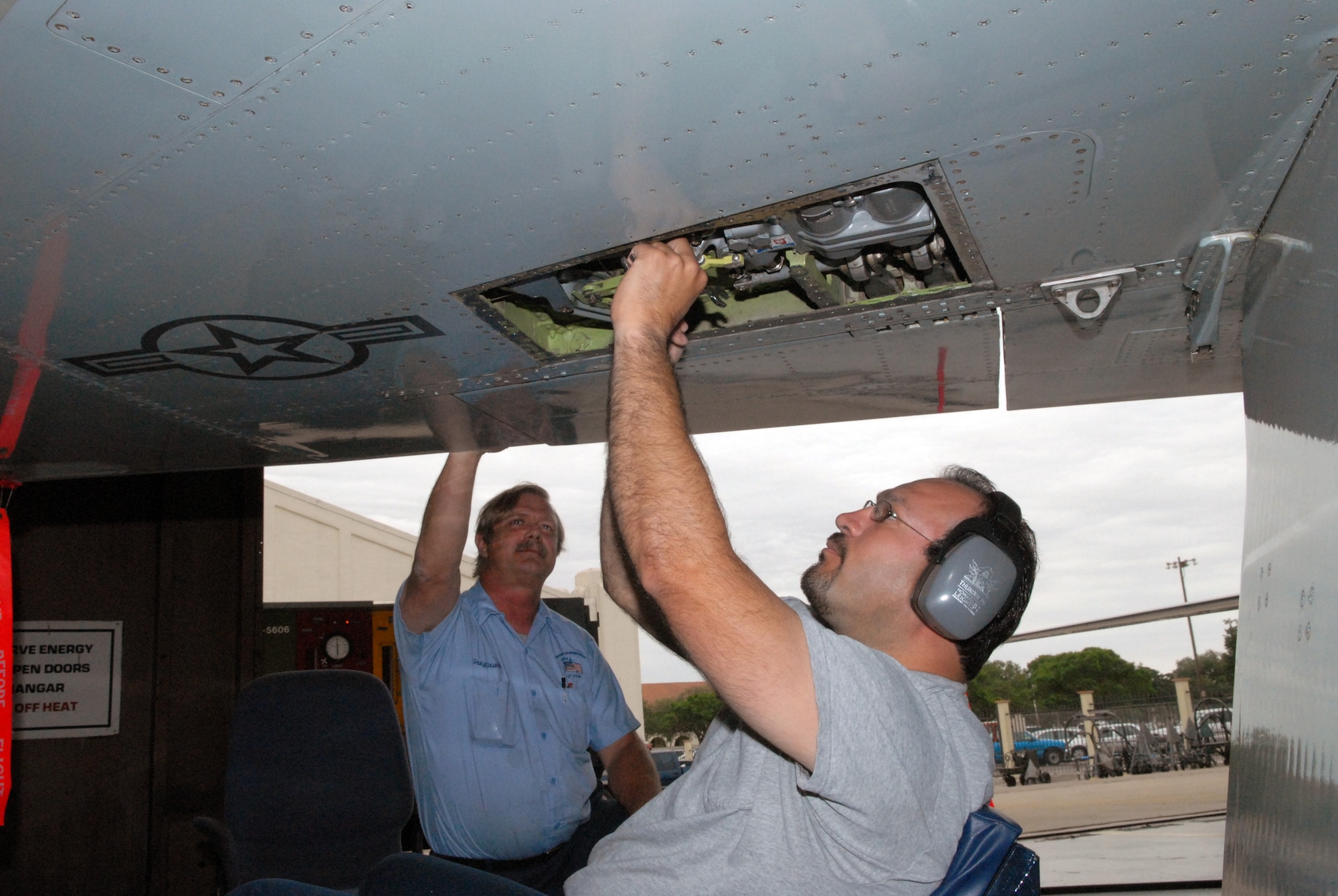 Gregg Gruver (left) watches as Roger Garza, both 12th Maintenance Directorate crewmen, performs routine T-38 Talon inspections. Crews conduct maintenance and inspections after each sortie pilots and students fly. (U.S. Air Force photo by Rich McFadden)