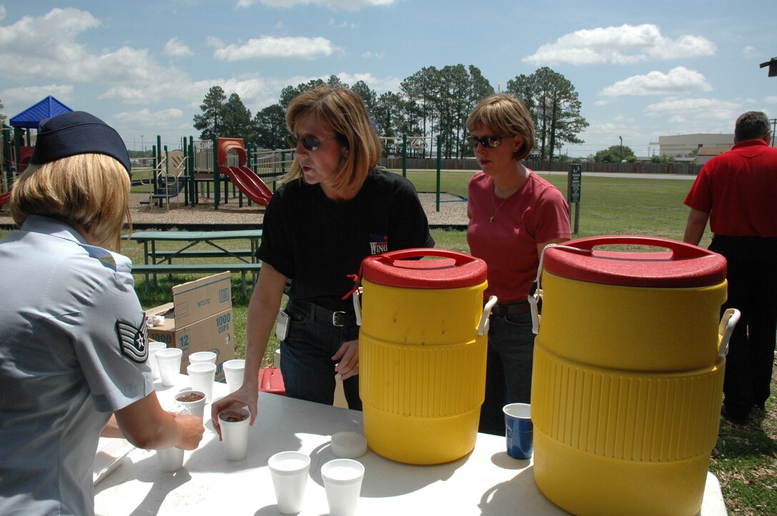 Chief Master Sergeant Ann Hamilton, 315th Aerospace Medicine Squadron, helps Technical Sergeant Danielle Jarell, 317th Airlift Squadron, Charleston Air Force Base, S.C., with the drink selection at the Charleston Chief’s Group Fish Fry that was held at the base picnic grounds on Friday, May 16. (photo by Debra Baldwin)