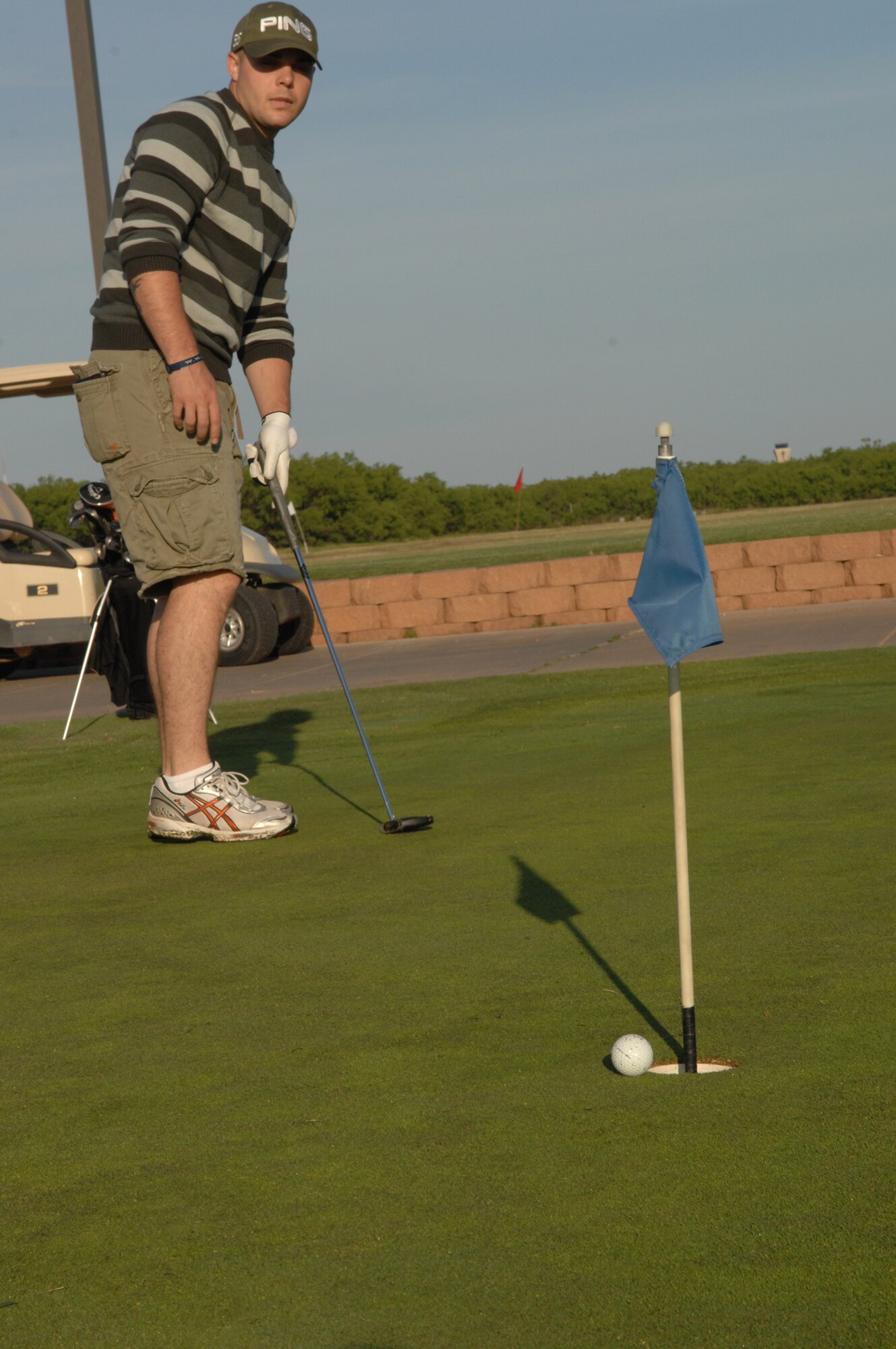 DYESS AIR FORCE BASE, Texas -- Airman 1st Class William Hinson, 7th Medical Support Squadron, practices his putting before a golf tournament May 16. The golf tournament was one of the many events Dyess celebrated during the annual Sports Day. (U.S. Air Force photo by Airman 1st Class Jennifer Romig)