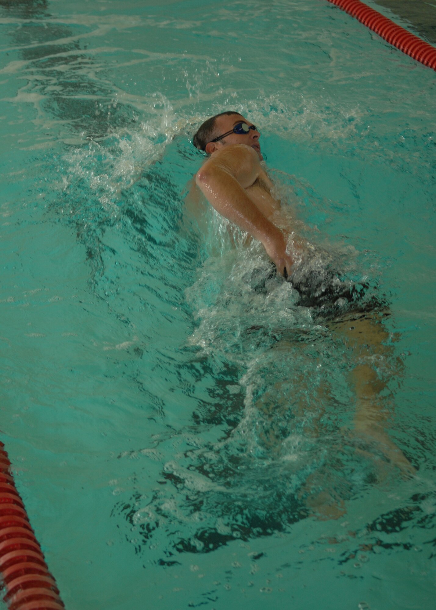 DYESS AIR FORCE BASE, Texas -- Tech. Sgt. Trevor Jackson, 7 Services Squadron, finishes his four laps during the triathalon May 16. The triathalon was one of the many events during Sports Day, there was also basketball, 5K run, and dodgeball. (U.S. Air Force photo by Airman 1st Class Jennifer Romig)