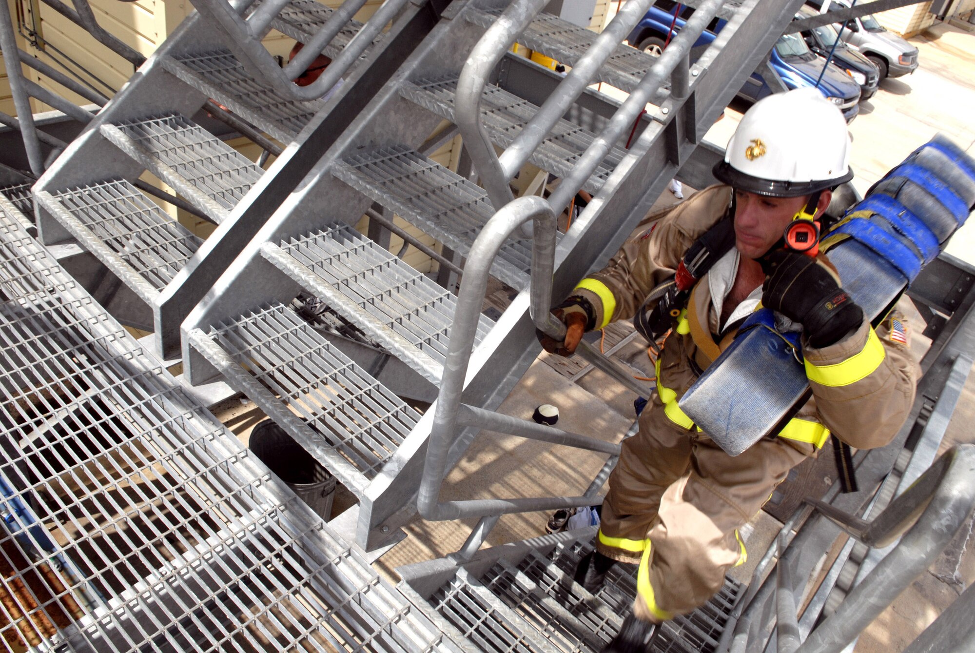 Marine Corps Staff Sgt. Charles Ammon, a member of the SAMSquad, carries a 45-pound hose up five stories during the first part of the Firefighter Combat Challenge course Wednesday at the Louis F. Garland Fire Academy in preparation for a competition this weekend in Brandon, Mississippi. This year’s SAMSquad members are Marine Staff Sergeants Charles Ammon and Nicholas Cook, Marine Sgt. William Alexander and Air Force Staff Sergeants William Gates and Kevin Wasiewski. (U.S. Air Force photo by Senior Airman Kamaile Chan)