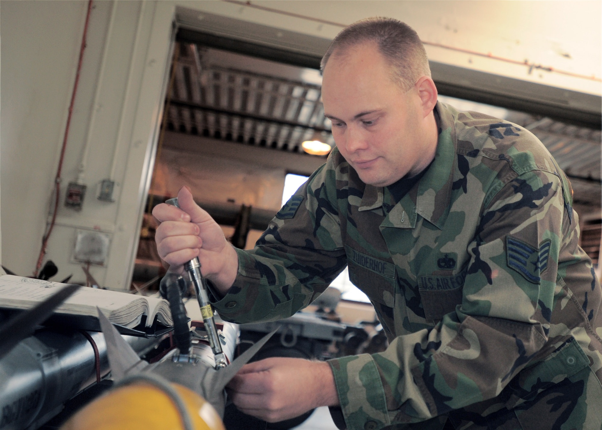 Staff Sgt. Wayne Zuiderhof torques the wing assembly of a weapon body May 14 at Elmendorf Air Force Base, Alaska. Sergeant Zuiderhof, assigned to the 3rd Equipment Maintenance Squadron Munitions Flight, was one of two recipients of the 2007 AIM-9X Cutting Edge Award. (U.S. Air Force photo/ Airman 1st Class Laura Turner) 