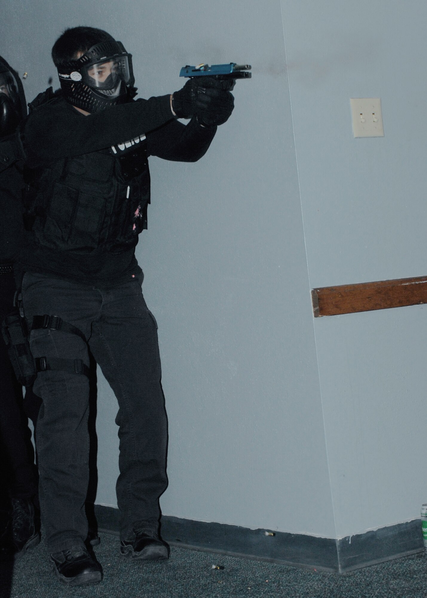 A local police officer fires a simunition round toward an active shooter during a training course May 7 at Cannon Air Force Base, N.M. The three-day Patrol Response to Active Shooter course is taught by National Tactical Officers Association members. (U.S. Air Force photo/Airman 1st Class James R. Bell) 