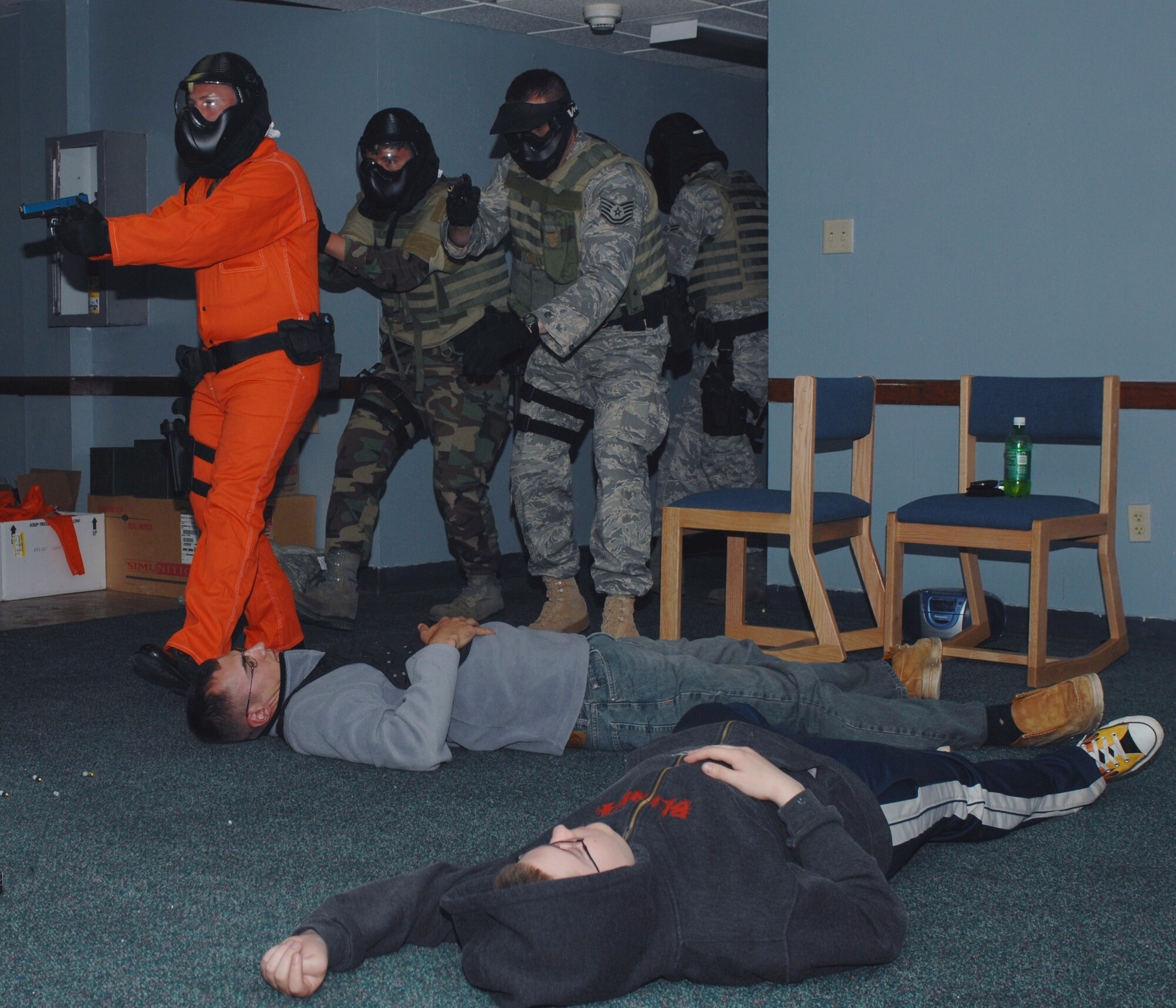 "Casualties" lay on the floor of a vacated dormitory during a mock critical hostage situation May 7 at Cannon Air Force Base, N.M. The first four-man team went forward to neutralize the threat as the second team (pictured) evacuated the injured. (U.S. Air Force photo/Airman 1st Class James R. Bell) 