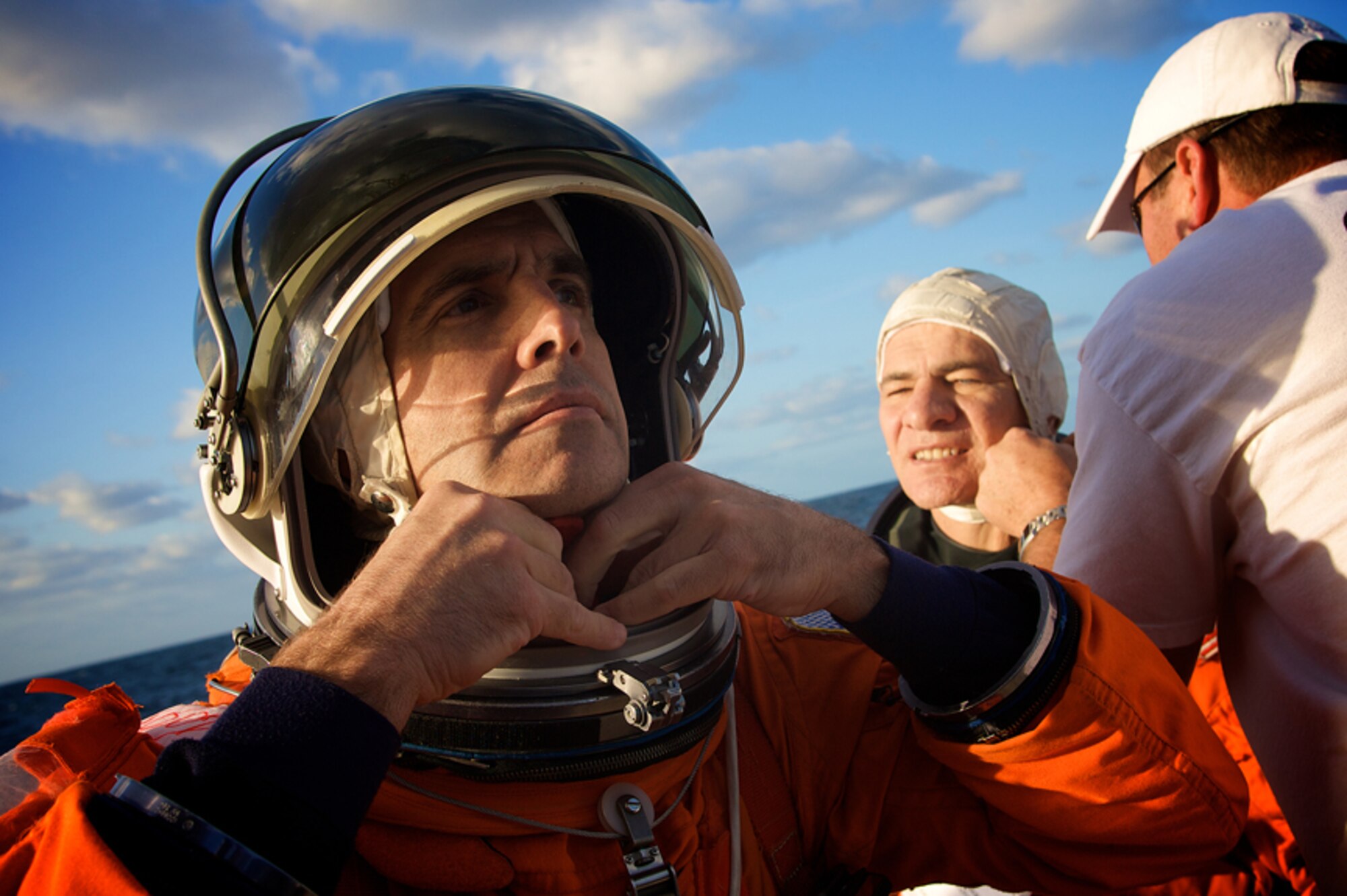 PATRICK AIR FORCE BASE, Fla. -- Astronauts Rick Mastracchio, front, and Paolo Angelo Nespoli, don their flight suits just before being dropped into the Atlantic Ocean to await rescue by Air Force Reserve pararescuemen from the 920th Rescue Wing during an annual search and rescue exercise.  Members of the 920th RQW are part of a joint task force that supports Space Shuttle launches and are always ready in the event of an emergency. (U.S. Air Force photo/Tech. Sgt. Jeremy Allen)