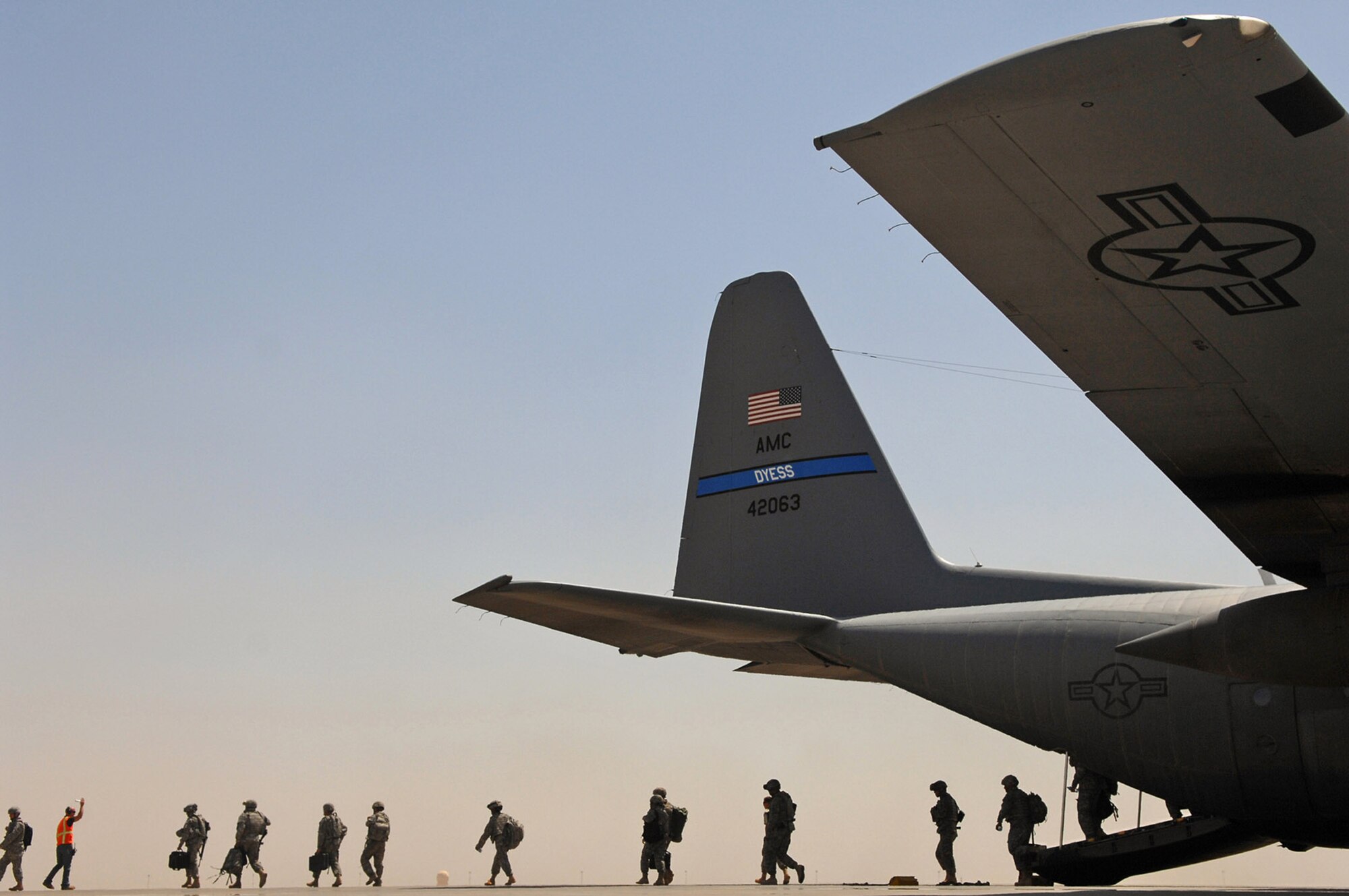 Servicemembers exit a C-130 Hercules May 10 at Balad Air Base, Iraq. Members of the 777th Expeditionary Airlift Squadron help prevented convoy vehicles and servicemembers from traveling along improvised explosive device-laden Iraqi roads by airlifting troops and supplies throughout the area of operations. (U.S. Air Force photo/Senior Airman Julianne Showalter)