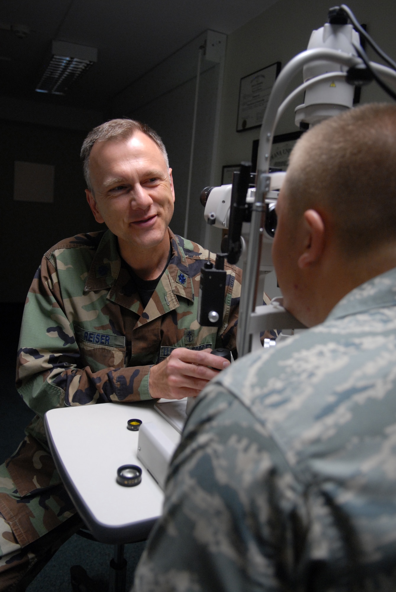 Lt. Col (Dr.) Daniel E. Reiser, 435th Aerospace Medical Squadron Optometry Flight commander, examines a patient's eyes on Ramstein May 15. Doctor Reiser was installed as president of the Armed Forces Optometric Society. (U.S. Air Force photo by Airman 1st Class Ruth Holcomb)(Released)