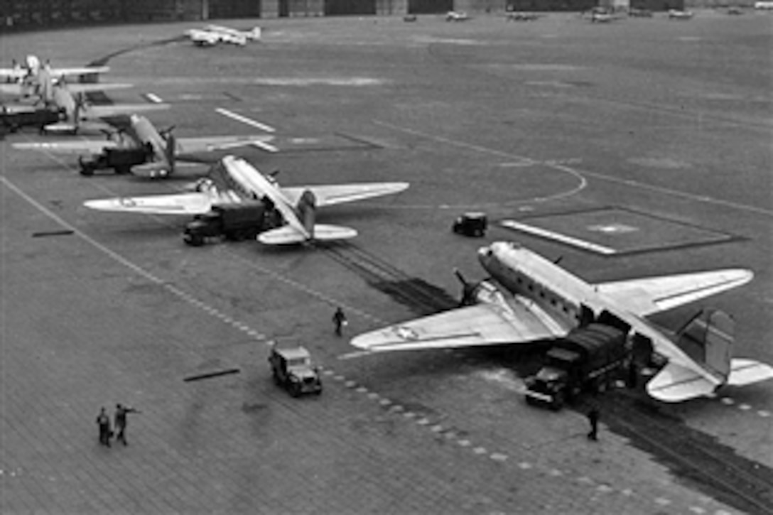 The Joint Services Open House at Andrews Air Force Base, Md., this weekend will pay tribute to the pilots of the Berlin Airlift as the 60th anniversary of the historic supply effort approaches in June. In this image, C-47 transport planes, each containing 190 sacks of flour, are shown arriving at Tempelhof Airport, July 2, 1948. A pair of B-17 weather aircraft can be seen at the far side of the airfield along with a lone C-54 at the extreme right. 