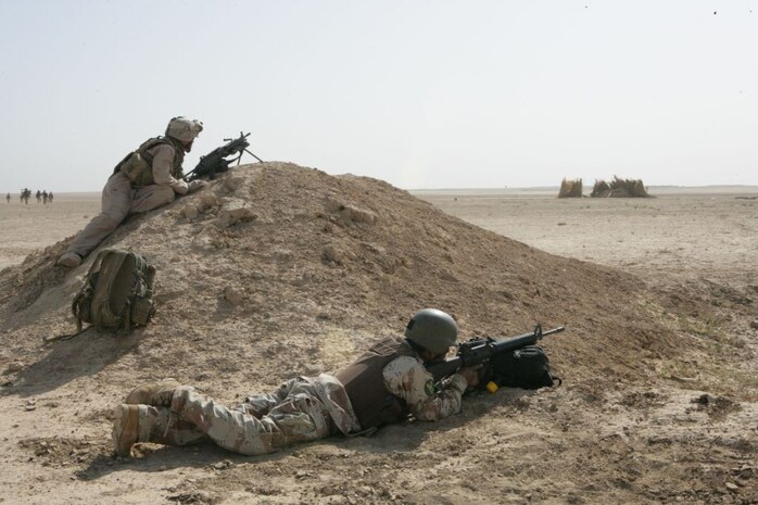 RAMADI, IRAQ (May 16, 2008)- Lance Cpl. Nicholas K. Bradley, a squad automatic weapon gunner with 1st Battalion, 9th Marine Regiment, Regimental Combat Team 1, and an Iraqi Army Soldier provide security during Operation Spring Break near the south side of Lake Tharthar in al Anbar Province May 13. While operating in the area, the Marines were able to build relationships with the locals. â??The results (of the operation) were quite successful,â? said Maj. Jeff McCormack, the operations officer for 1st Battalion, 9th Marine Regiment, Regimental Combat Team 1. â??We found a weapons cache and established ties with the local fisherman. Some of the fisherman said theyâ??ve never seen an American or hadnâ??t seen an American since 2004. Everybody was very happy to see the Marines and Iraqi Army working together. So now, we feel when we go back there, we will have some locals that we can go talk to.â?  (Official U.S. Marine Corps photo by Lance Cpl. Adam J. Root/Released)