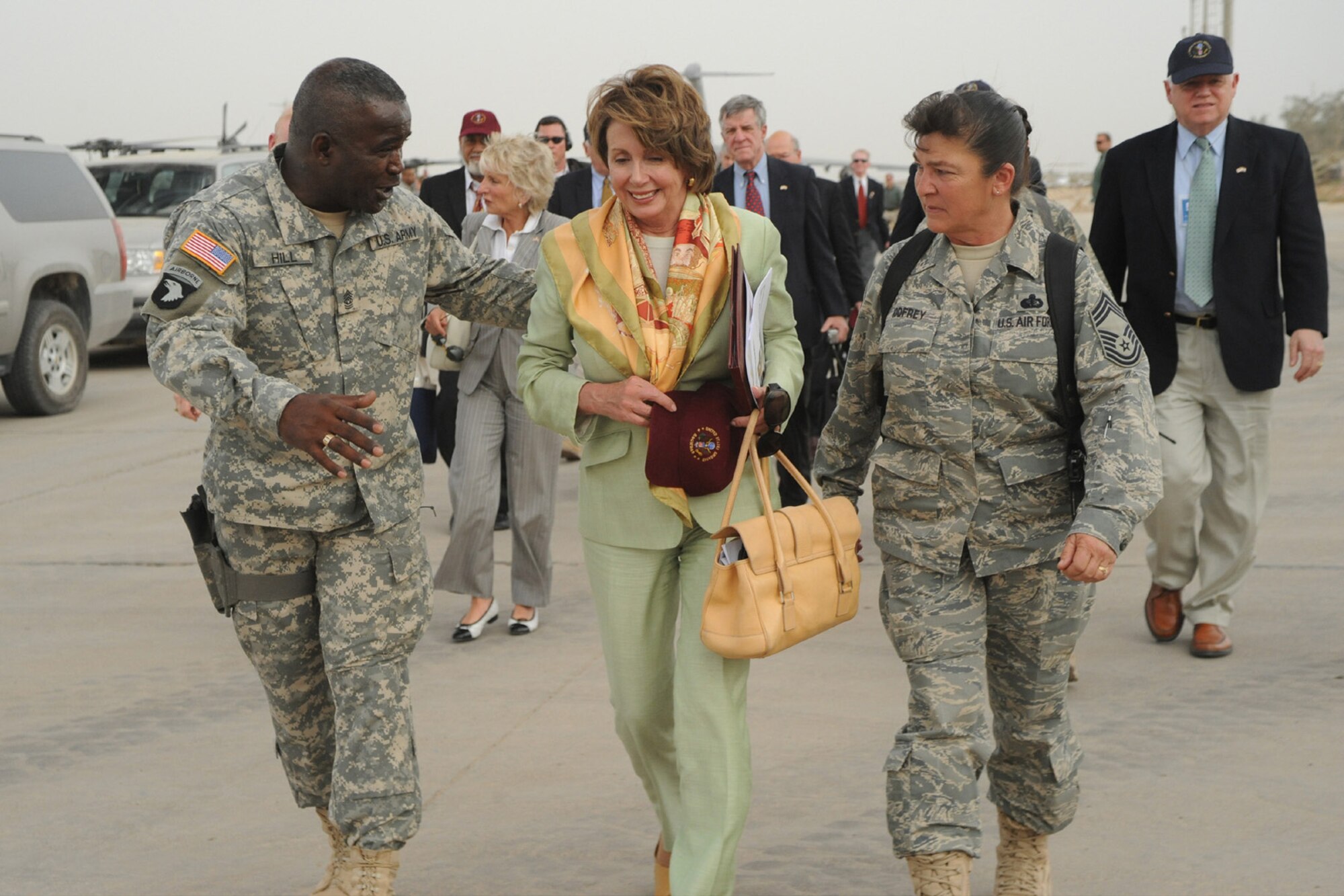 SATHER AIR BASE, Iraq -- Command Sgt. Maj. Marvin Hill, command sergeant major, Multi-National Force - Iraq (left), and Chief Master Sgt. Kathryn Godfrey, 447th Air Expeditionary Group superintendent, walk with Speaker of the House, Nancy Pelosi, on her way to visit with Airmen and Soldiers here May 17. Ms. Pelosi and seven other members of the U.S. House of Representatives visited Sather AB, adjacent to Baghdad International Airport. (U.S. Air Force photo/Tech. Sgt. Amanda Callahan)