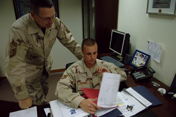 Staff Sgt. Brandon Hayden, 380th Air Expeditionary Wing Information Manager and Command Chief Master Sergeant Assistant, reviews documents with Chief Master Sgt. Kevin Slater, 380th AEW Command Chief Master Sergeant. Sergeant Hayden was the 380th AEW Warrior of the Week for the week of May 16, 2008 (U.S. Air Force Photo/Senior Airman Ross M. Tweten)