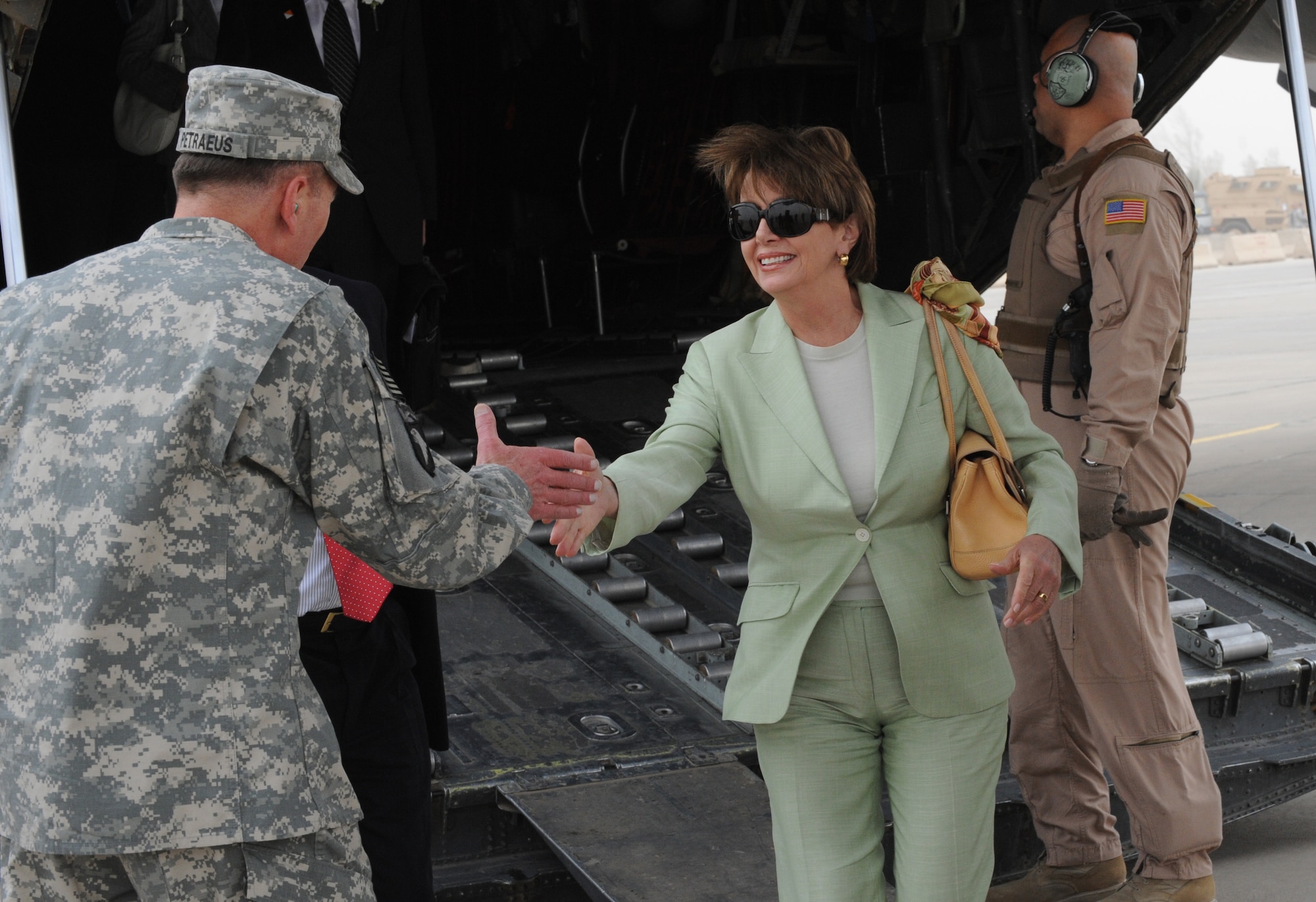 SATHER AIR BASE, Iraq -- Gen. David Patraeus, Multi-National Force - Iraq commanding general, greets Speaker of the House, Nancy Pelosi, as she and other U.S. representatives arrive here May 17 on a C-130 Hercules deployed from Dyess Air Force Base, Texas. (U.S. Air Force photo/Tech. Sgt. Amanda Callahan) 