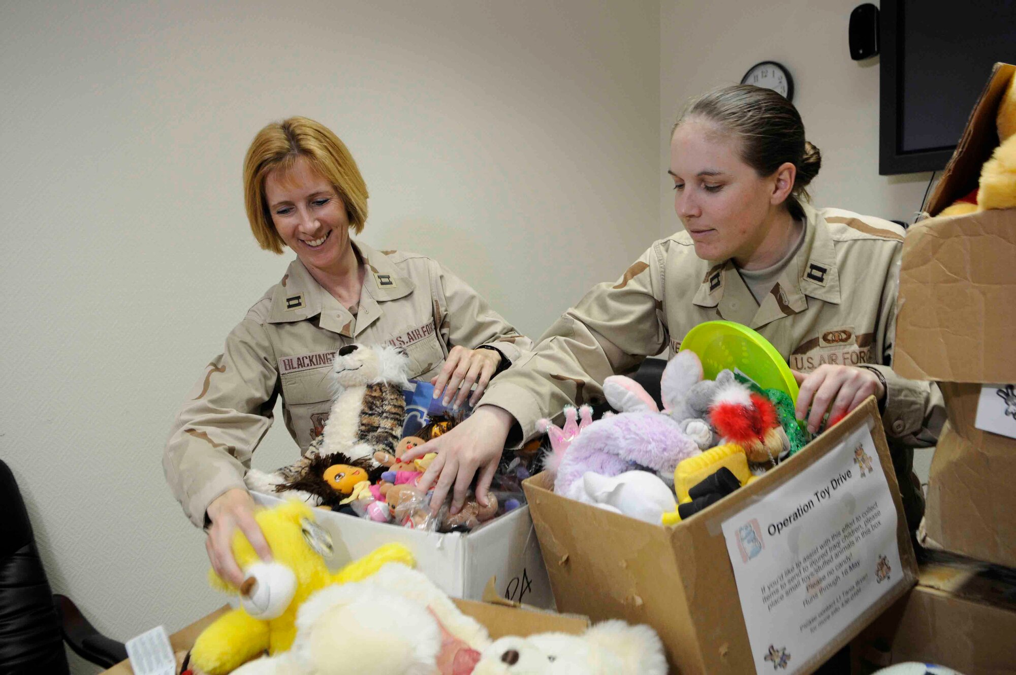 Company Grade Offi cers? Council president Capt. Nora Nelson and Operation Toy Drive coordinator Capt. Carol Blackington sort through the toys collected by a group of about 40 volunteers here, May 16. The toys will be donated to Iraqi orphans.