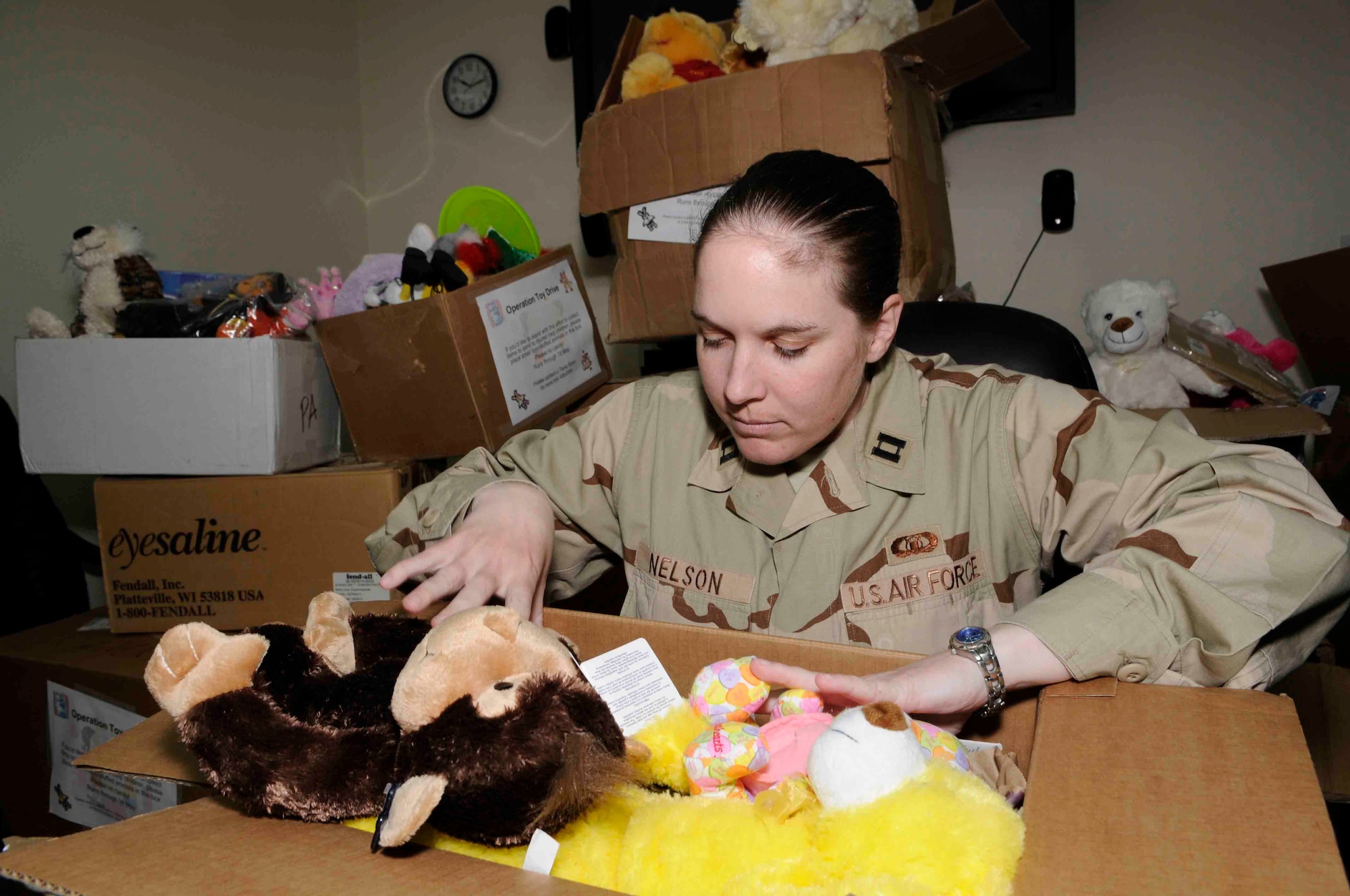 Capt. Nora Nelson takes inventory of the toys that have been collected in
an initiative spurred by her niece and nephew to collect toys and games for
Iraqi orphans.