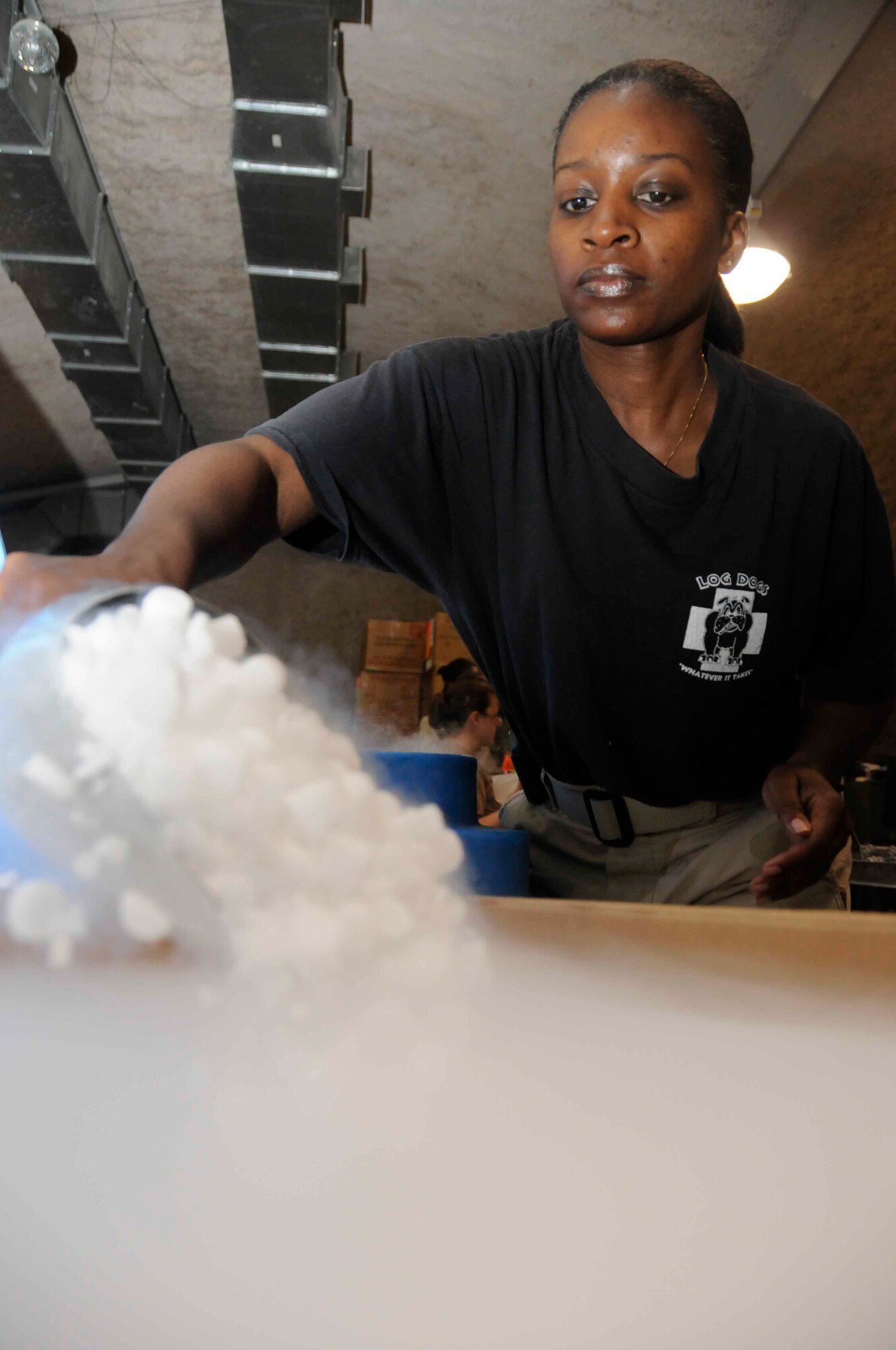 Tech. Sgt. Paula Todd, NCOIC of the BTC, scoops dry ice into a box used for shipping blood May 6. Sergeant Todd is responsible for inventory and shipment of blood products throughout the Persian Gulf region.