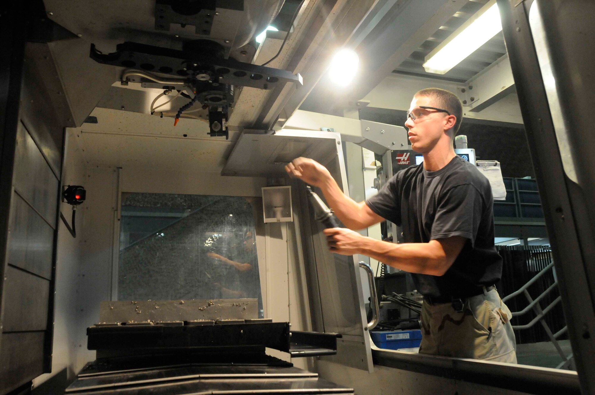 Senior Airman Michael Rogers, 379th Expeditionary Maintenance Squadron metals technician, cuts through a slab of metal using heavy machinery May 14. The alignment will improve the angle of attack measurement for the KC-135. Metals technicians can sculpt metal to form tools and parts used to repair aircraft. They provide parts for mission requirements in lieu ordering parts from a non-military source.(U.S. Air Force photo/ Senior Airman Domonique Simmons)