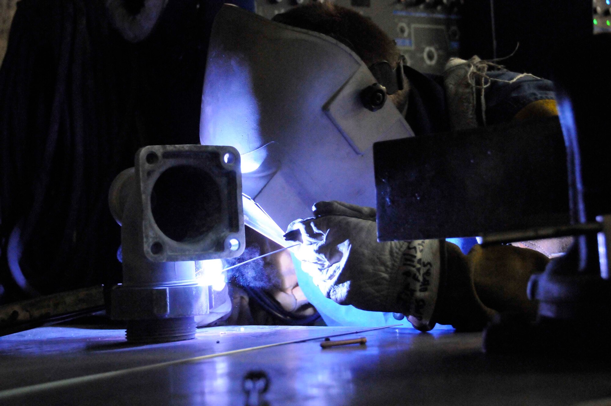 Senior Airman Jim Ollis, 379th Expeditionary Maintenance Squadron metals technician, welds a part for a Blatchford-Preston Complex fire hydrant here May 14. The metals tech shop aids the 379th Expeditionary Civil Engineer Squadron by providing convenient and money-saving repairs to improve mission effectiveness. (U.S. Air Force photo/ Senior Airman Domonique Simmons)