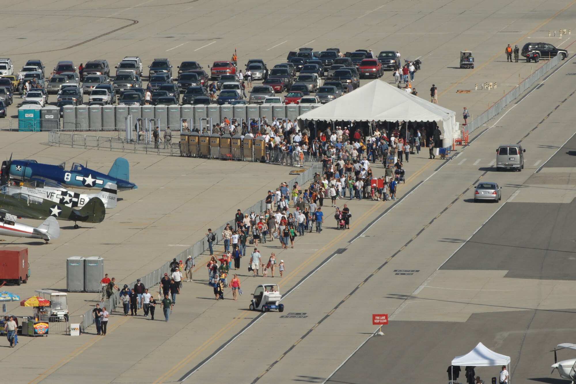 Hundreds of people make there way early in the day onto the flight line at the March ARB AirFest '08.  The AirFest featured both military and civilian aerial and ground demonstrations during the two day air show, May 3-4, 2008 at March Air Reserve Base, Riverside, California. (U.S. Air Force photo by SrA Dayton Mitchell)