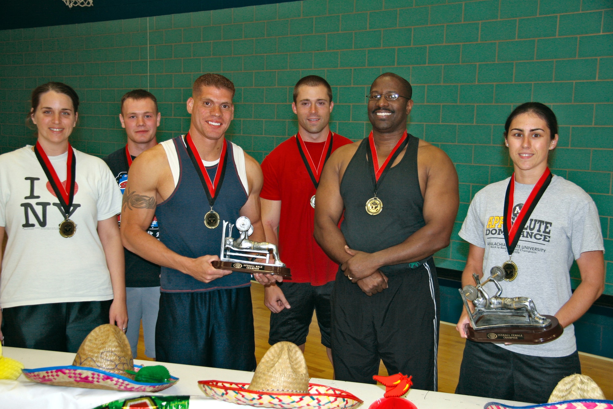 Posing  for a group photo after the bench press competition May 5 are (from left to right) Elycia Fine, heavy weight class 1st place (female); Nick Knihal, light weight class 1st place; Jeffrey Velazquez, mid weight class 1st place (male) and overall winner; Dan Reiff, heavy weight class 1st place; (male); Matt Moses, super heavy weight class 1st place, and Tammi Weldon, mid weight class 1st place (female). In addition to the contest, participants ate Mexican food and celebrated the anniversary of the defeat of the French army at Pueblo by Mexican forces. (U.S. Air Force photo by Julie Manuel)