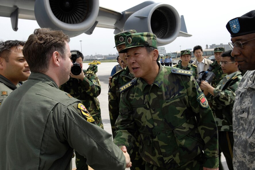 CHENGDU, People's Republic of China (May 18, 2008) --  Senior Captain GUAN Youfei, Deputy Director of the Foreign Affairs Office of the Chinese Ministry of National Defense, greets the first of two U.S. aircrews delivering earthquake relief supplies.  The two C-17 U.S. Globemaster aircraft carried food, water containers, blankets, generators, laterns and various hand tools.  Secretary of Defense Robert Gates, in support of the U.S. Department of State, authorized U.S. Pacific Command to support earthquake relief efforts in the People's Republic of China.  (US Air Force photo by Tech. Sgt. Chris Vadnais)