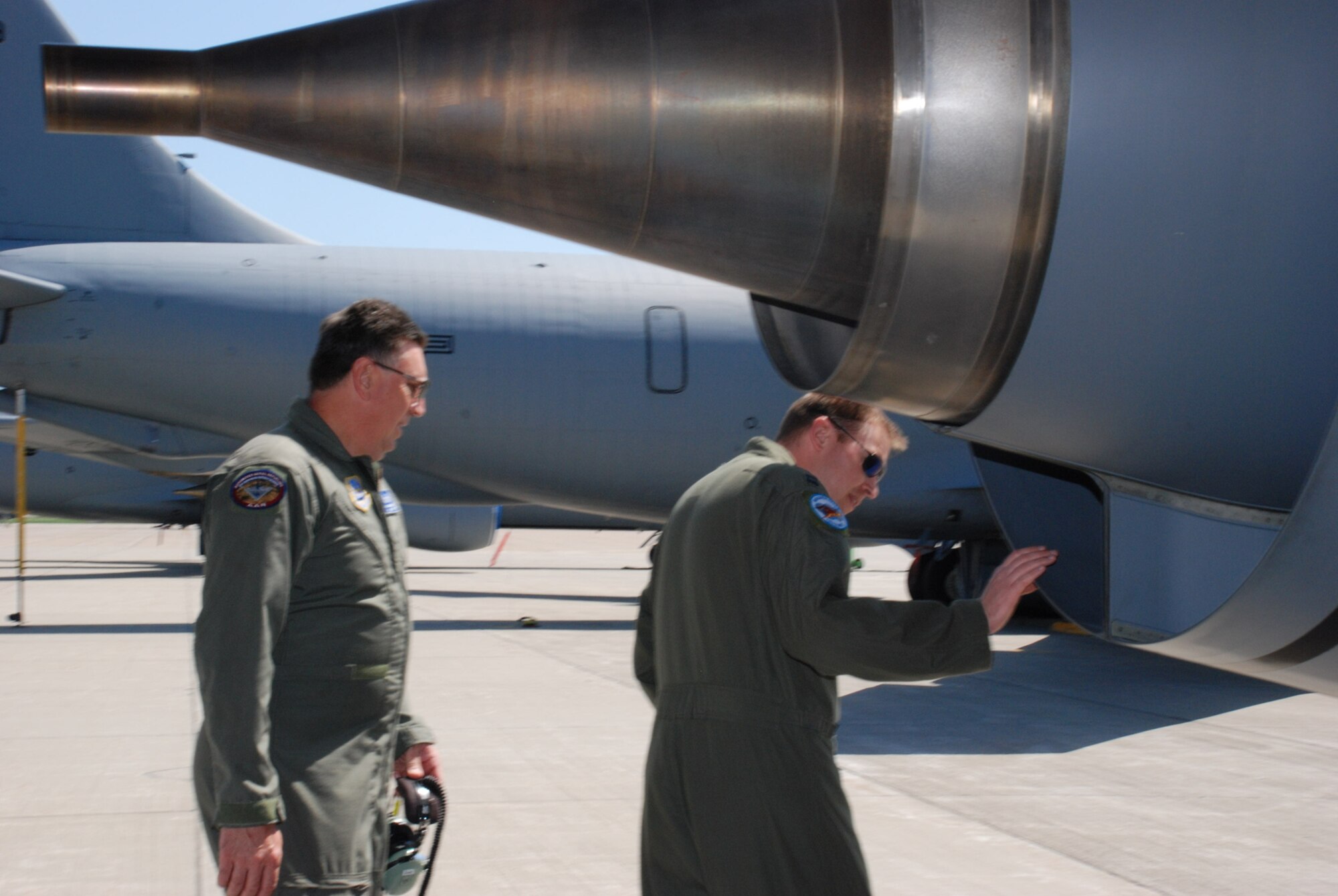 Capt. Jason Thomas, 107th Airlift Wing, Pilot, looks over a KC-135 as part of a preflight inspection here before the aircraft flies her last refueling mission with the 107th on April 22.  Also in the photo, Master Sgt. Stephan Kovacs, 107th AW, helps perform a preflight inspection on his aircraft. The aircraft will soon leave Niagara Falls for the 126 ARW, Scott AFB, Illinois Air National Guard as the 107th converts to C-130H2's.  (U.S. Air Force photo/Staff Sgt. Rebecca Kenyon).