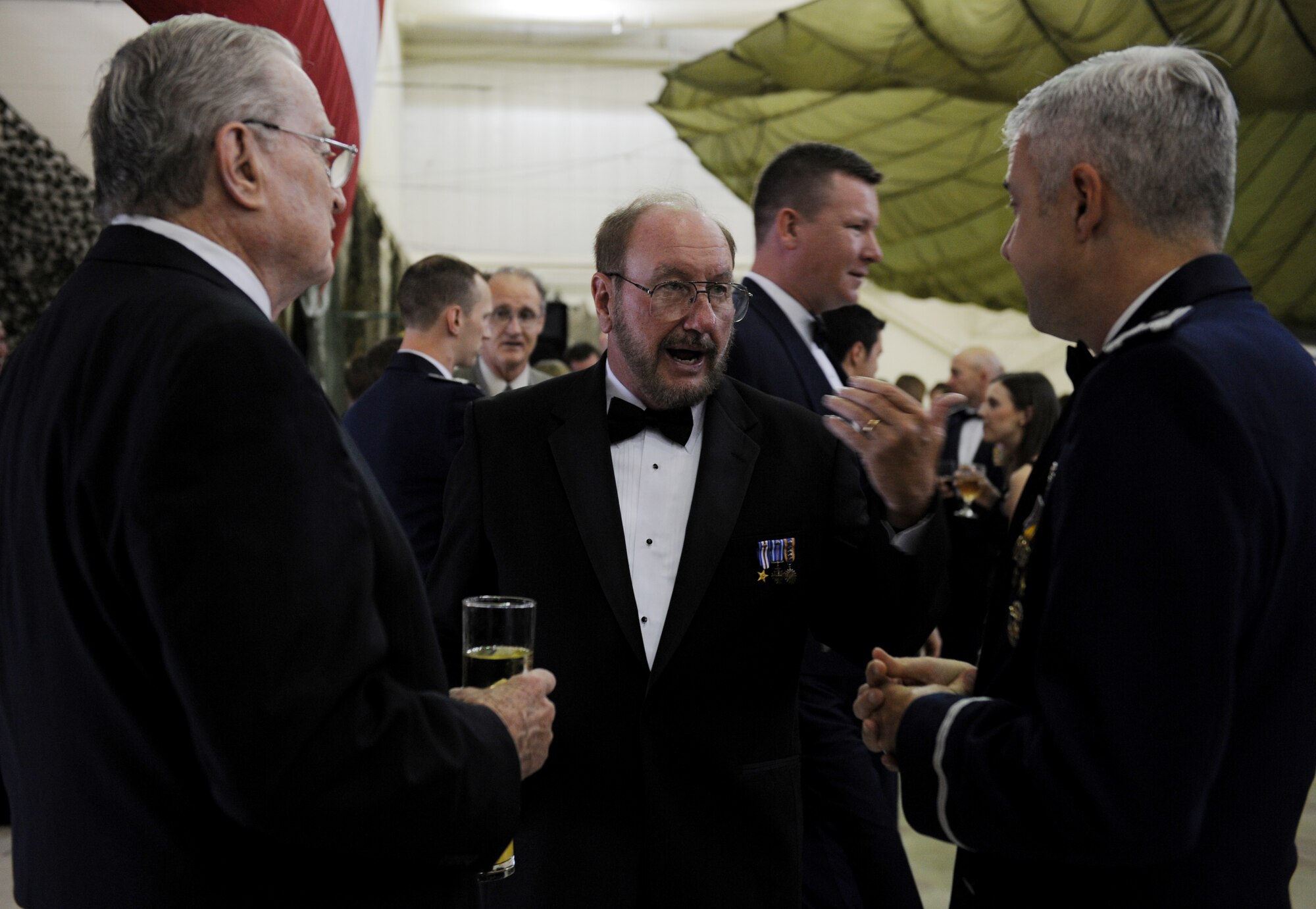 MOODY AIR FORCE BASE, Ga. -- Jim Beggerly, center, Society of Combat Search and Rescue president, speaks with Parker Greene, left, and Col. Kenneth Todorov,right, 23rd Wing commander, before the 347th Rescue Group dining out here May 16. Jim Beggerly is at Moody as part of the Society of CSAR symposium. (U.S. Air Force photo by Senior Airman Gina Chiaverotti)
