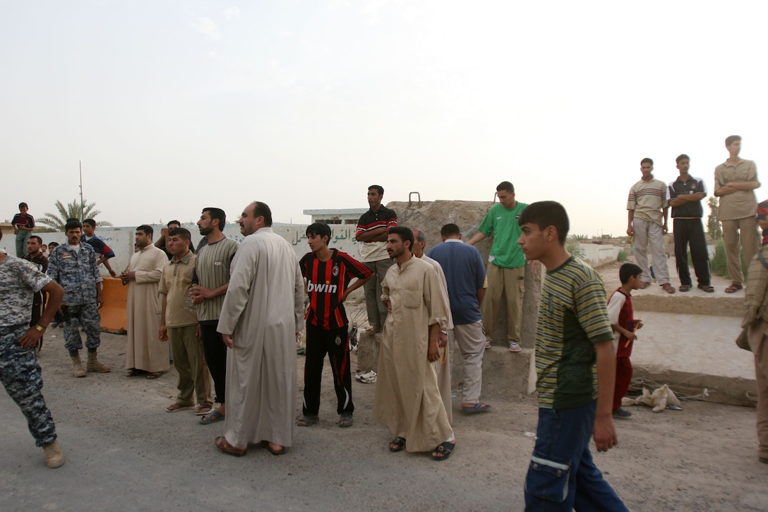 Local Iraqis wait outside of the Iraqi Police Station in Karma, Iraq, for their loved ones to return home, May 18. Approximately 40 Iraqis were released by the Iraqi Police and Marines of 2nd Battalion, 3rd Marine Regiment, Regimental Combat Team 1, after being screened and deemed not a threat to peace in the region. (Photo by Cpl. Chadwick deBree)