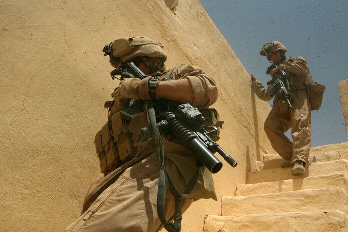Lance Cpl. Fix, 21, a scout team leader from Cleveland, Ohio, with Delta Company, 2nd Light Armored Reconnaissance Battalion, Regimental Combat Team 5, runs down a set of stairs followed by Pfc. Bradley R. Clifton, 18, a scout from Frankfort, Ky., with Delta Company, during a patrol through western Al Anbar province May 18. The company, nicknamed â??Outlaw,â?? supported the Navy SEALS in executing this operation to capture a key suspect May 19 in support of Operation Iraqi Freedom.