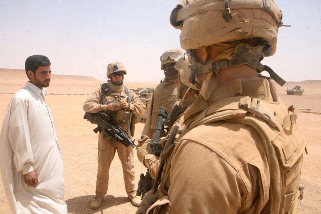 Marines with Delta Company, 2nd Light Armored Reconnaissance Battalion, Regimental Combat Team 5 question an Iraqi farmer during a patrol through western Al Anbar province, Iraq, May 18. The Camp Lejuene, N.C., based company, patrols the outskirts of Rutbah, Iraq, ensuring the farmers and traders are free from danger and receiving the supplies they need to cultivate their crops.