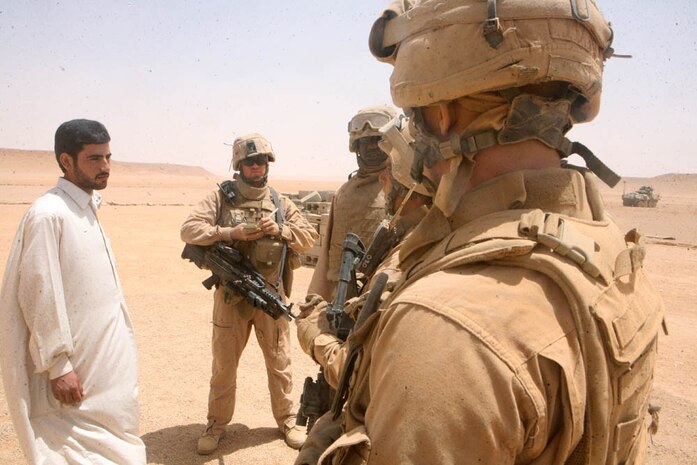 Marines with Delta Company, 2nd Light Armored Reconnaissance Battalion, Regimental Combat Team 5 question an Iraqi farmer during a patrol through western Al Anbar province, Iraq, May 18. The Camp Lejuene, N.C., based company, patrols the outskirts of Rutbah, Iraq, ensuring the farmers and traders are free from danger and receiving the supplies they need to cultivate their crops.